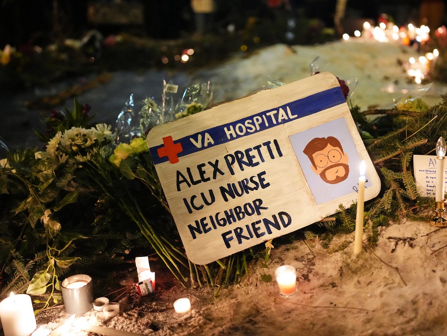 A photo of a hand painted sign made out to look like an ID badge, reading: VA Hospital, Alex Pretti, ICU Nurse, Neighbor, Friend. The sign is propped against flowers and candles on a snowy embankment.
