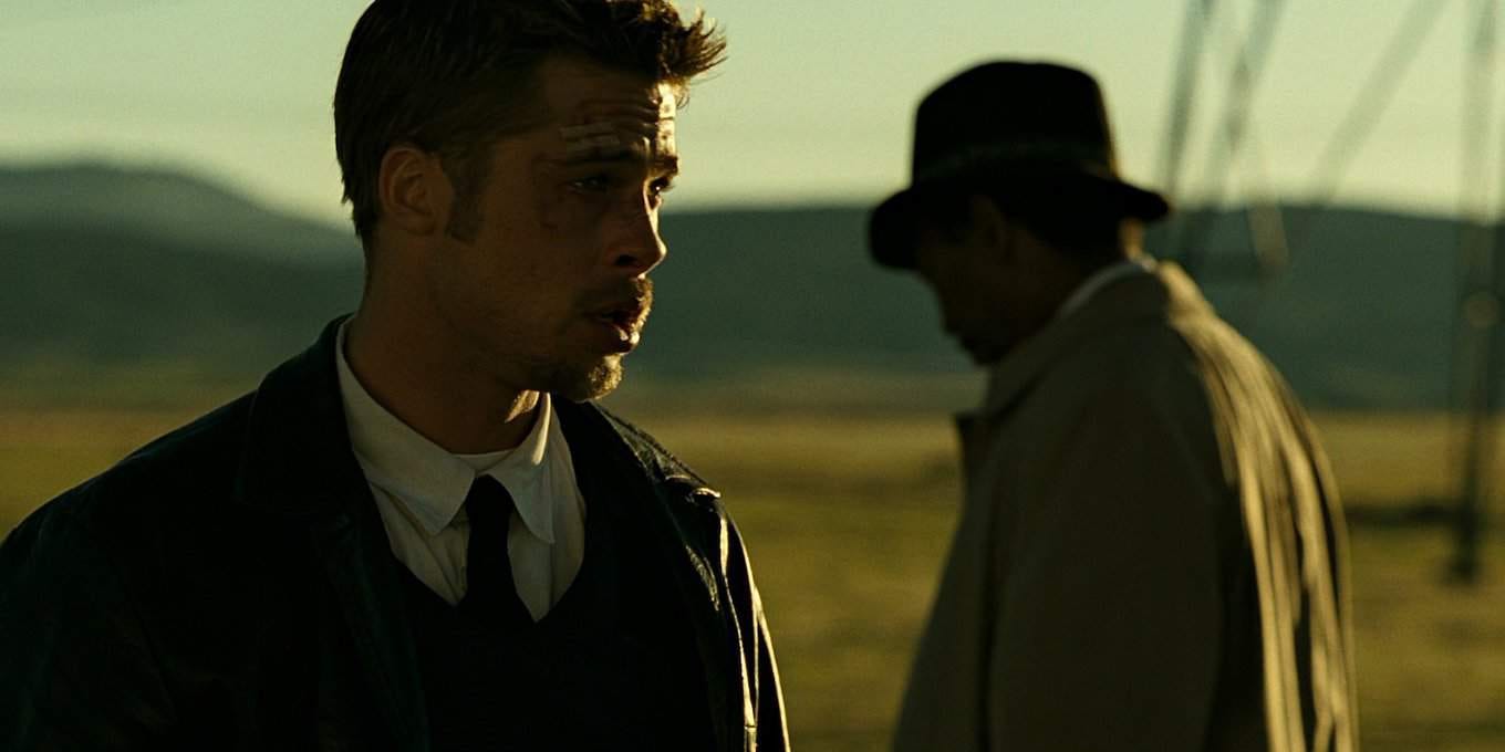 Brad Pitt looks distressed in front of an out-of-focus Morgan Freeman and some power lines Brad Pitt looks distressed in front of an out-of-focus Morgan Freeman and some power lines
