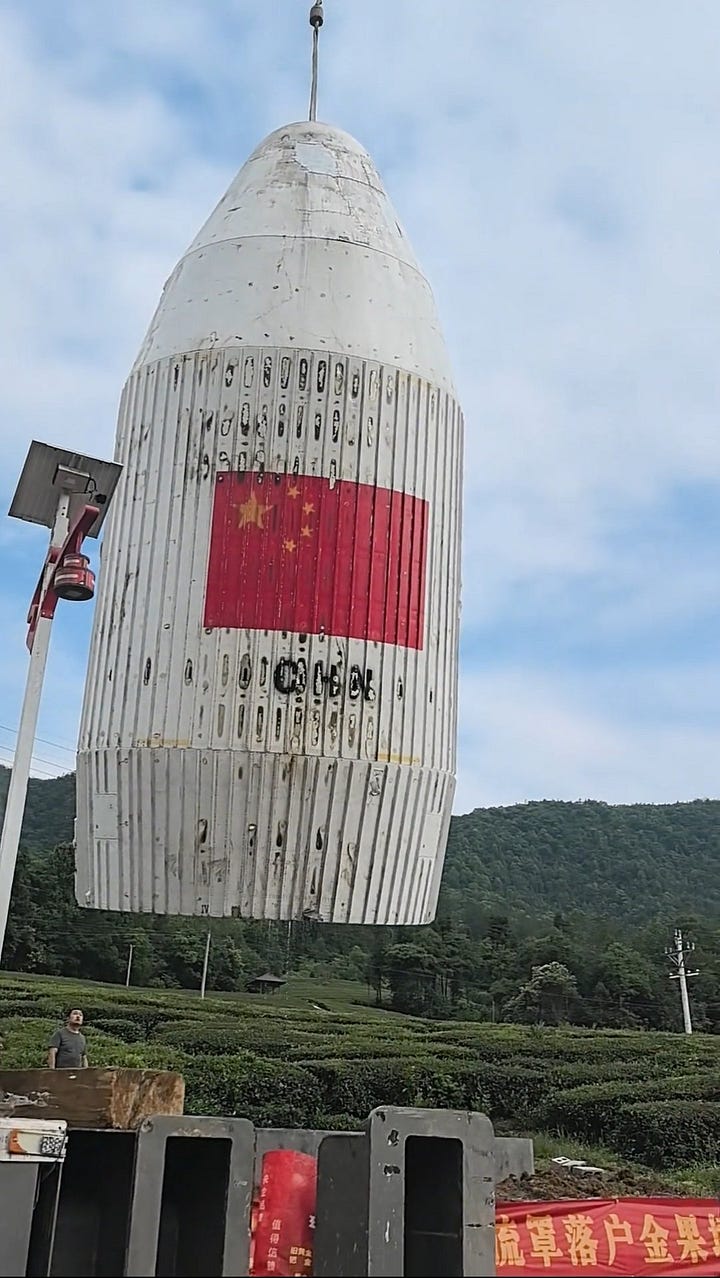 One of the Long March 4B's fairing halves being taken away following its discovery.