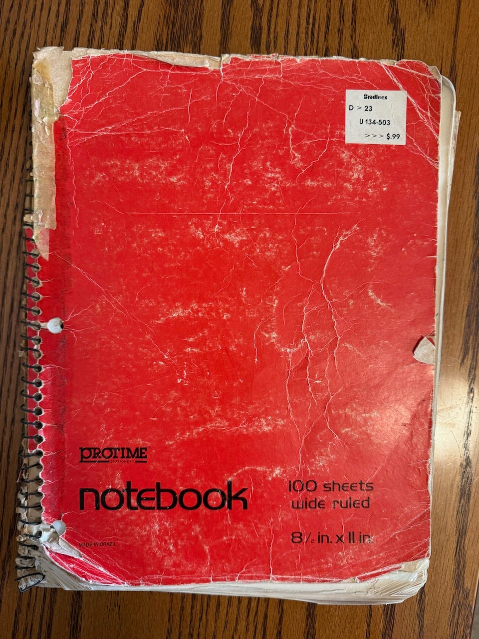 A red spiral-bound notebook.