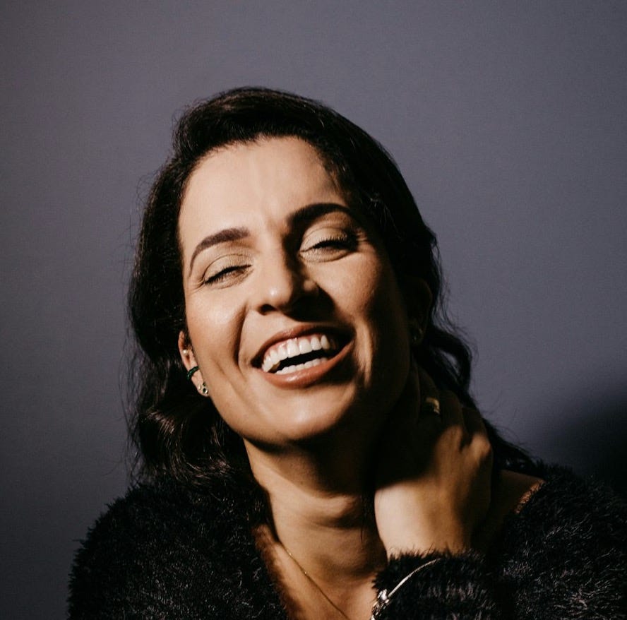 smiling woman in black fur coat