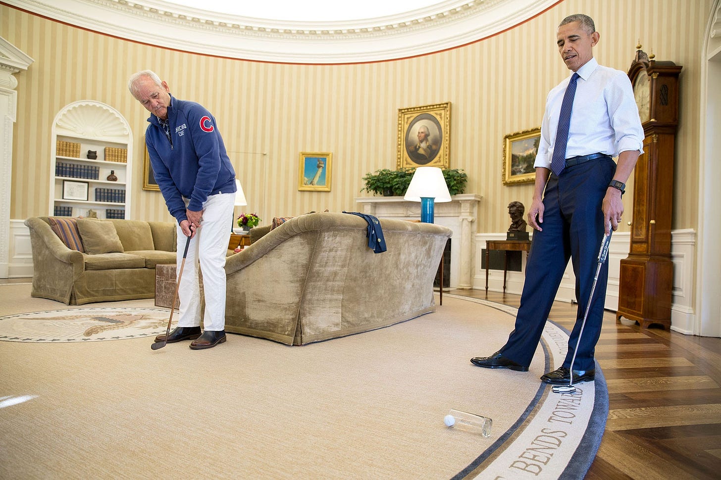 October 21, 2016: Bill Murray, in full Chicago Cubs attire, brings humor to the Oval Office, putting into a glass while promoting the Affordable Care Act, during his visit to receive the Mark Twain Prize. October 21, 2016: Bill Murray, in full Chicago Cubs attire, brings humor to the Oval Office, putting into a glass while promoting the Affordable Care Act, during his visit to receive the Mark Twain Prize.