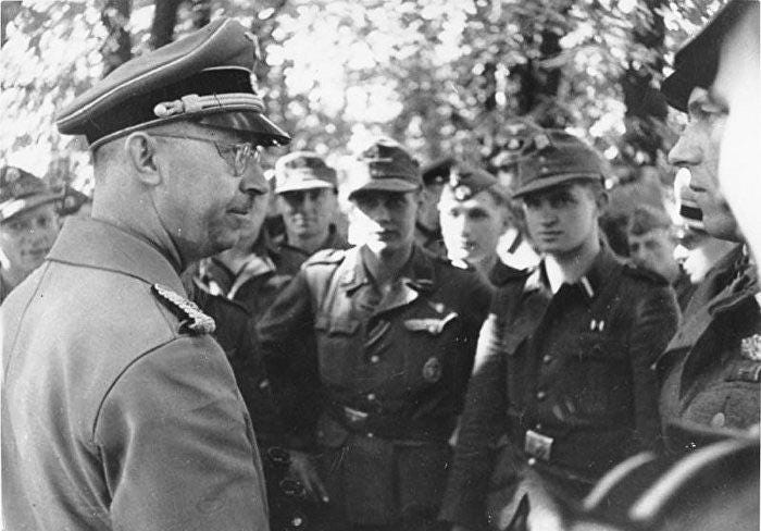 Photo of Heinrich Himmler, leader of the German SS, talking with Waffen-SS soldiers after crushing the Warsaw Uprising. (October 1944) Photo of Heinrich Himmler, leader of the German SS, talking with Waffen-SS soldiers after crushing the Warsaw Uprising. (October 1944)