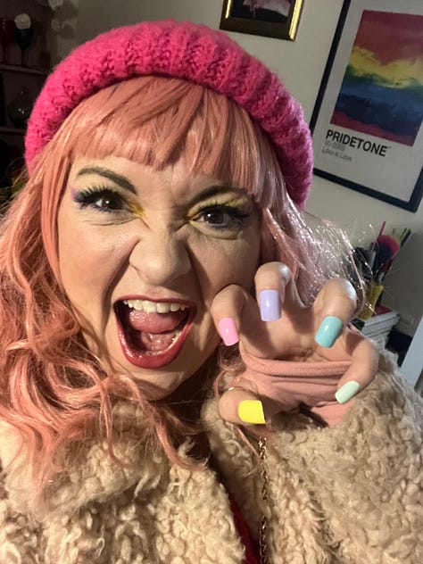 1) Hannah sits in a powerchair with pink sides, wearing a cord rainbow boilersuit and rainbow converse, on the TV on the Steph’s Packed Lunch Set. 2) Hannah dressed as Enid Sinclair, with pink wig and false rainbow nails 3) Hannah stands by her chair in a disabled loo, taking a photo in the mirror, wearing a sparkly green sleeveless v neck top and a big puffy green net skirt