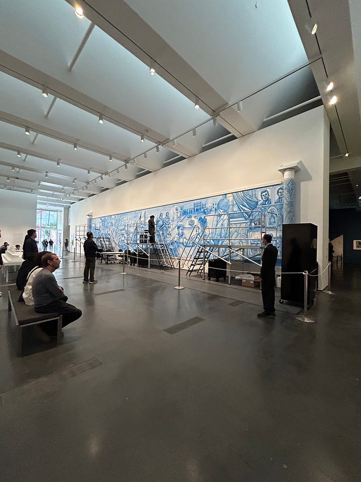 Urban Lights at sunset, Mark Bradford’s 150 Portrait Tone, a mural across a wall with Blank Panthers in it, lunch on a table outside, fluorescent lightblubs on their side on the wall, Magritte's The Treachery of Images, and a painting by Diego Rivera.