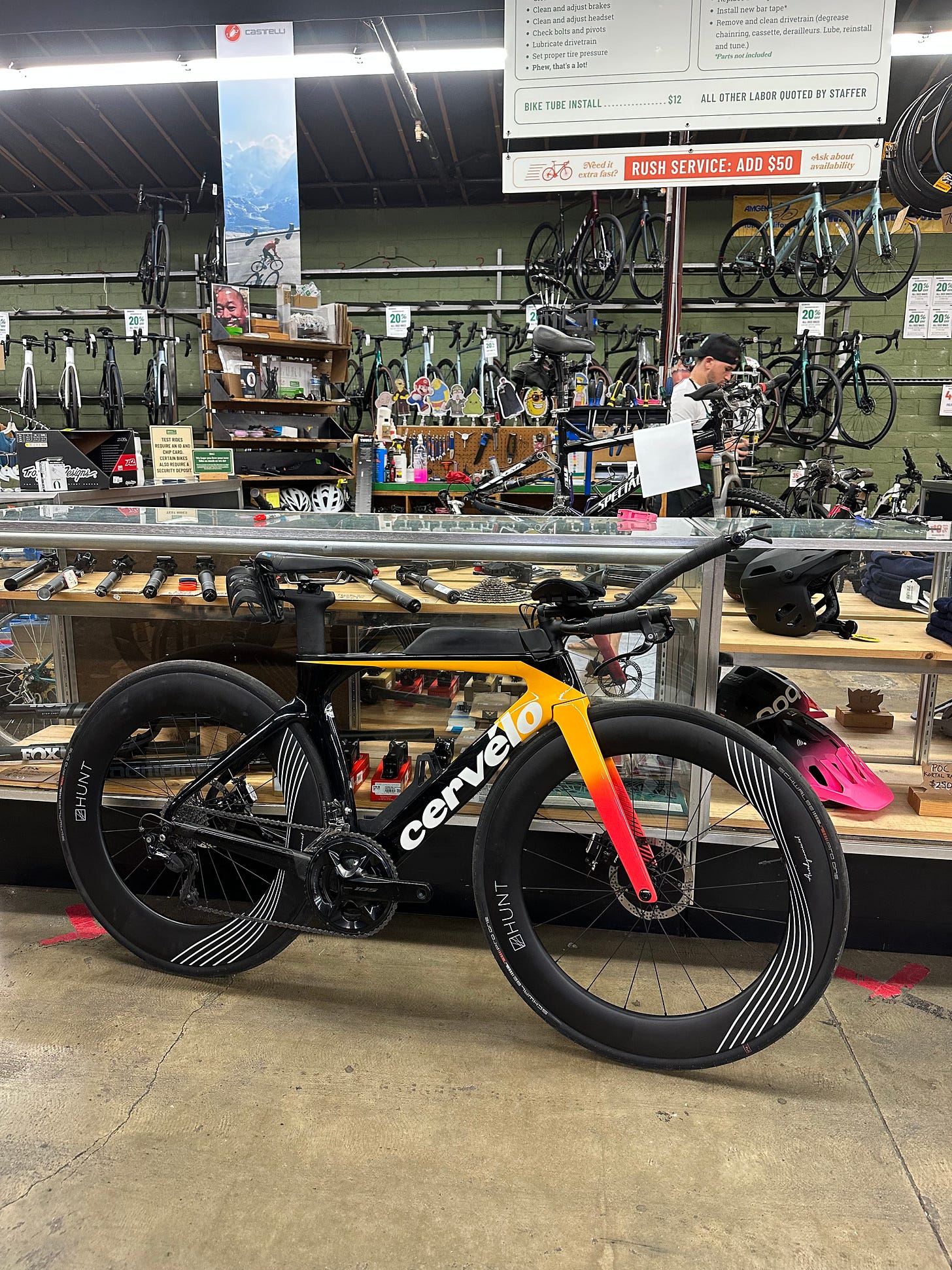 Tri bike leaning against a glass case at a bike shop
