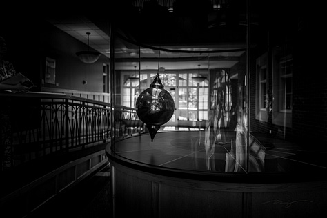 dinosaur skeleton, pendulum, abstract lines on sidewalks