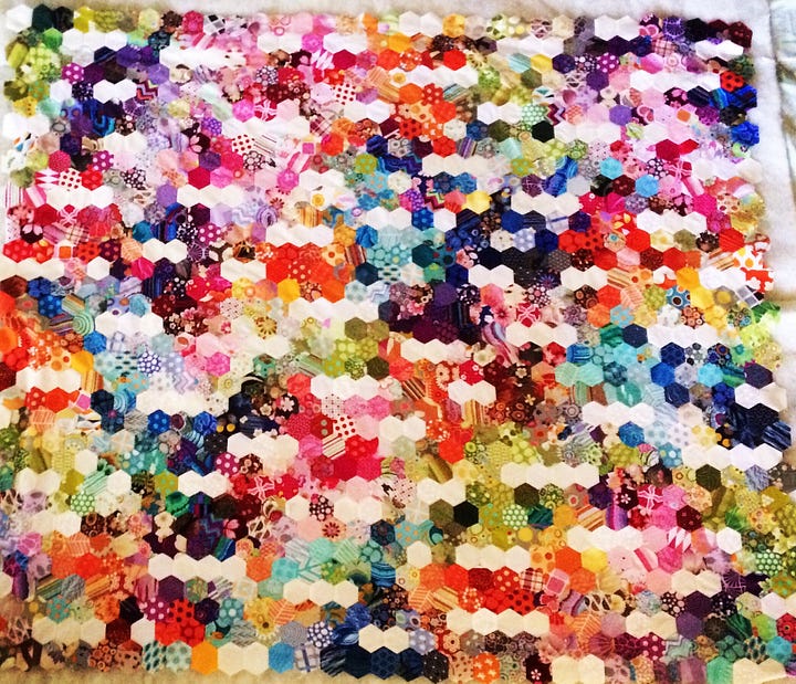 two different quilts made with hexagon shaped pieces, one on the left is flowers and the other on the right is patterned differently to show bars