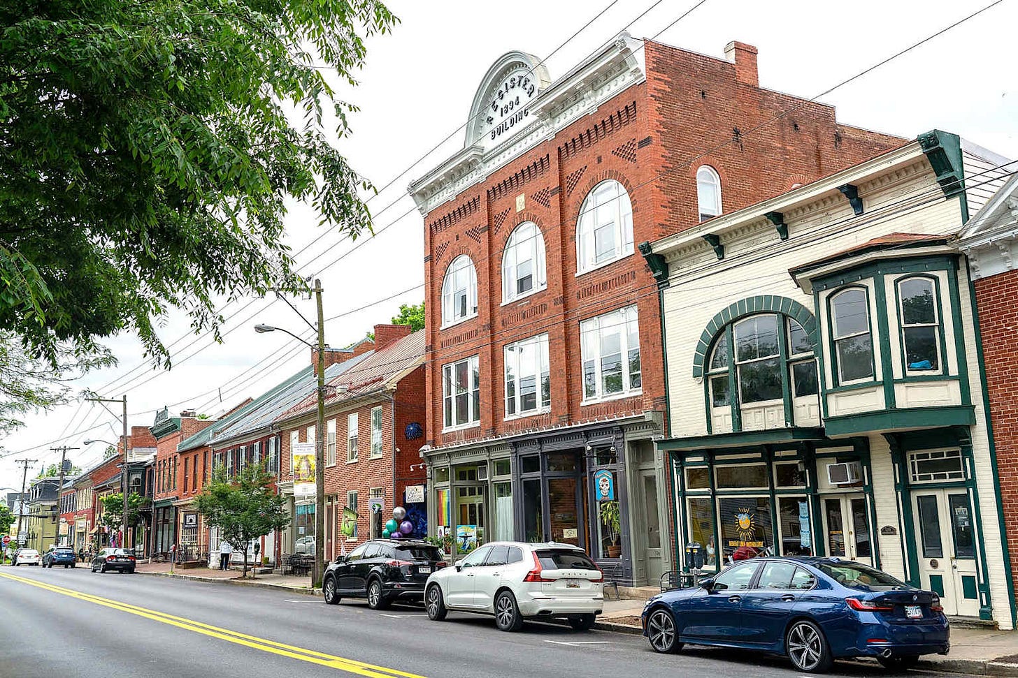 A charming street scene showcasing local businesses along a main street in a West Virginia small town