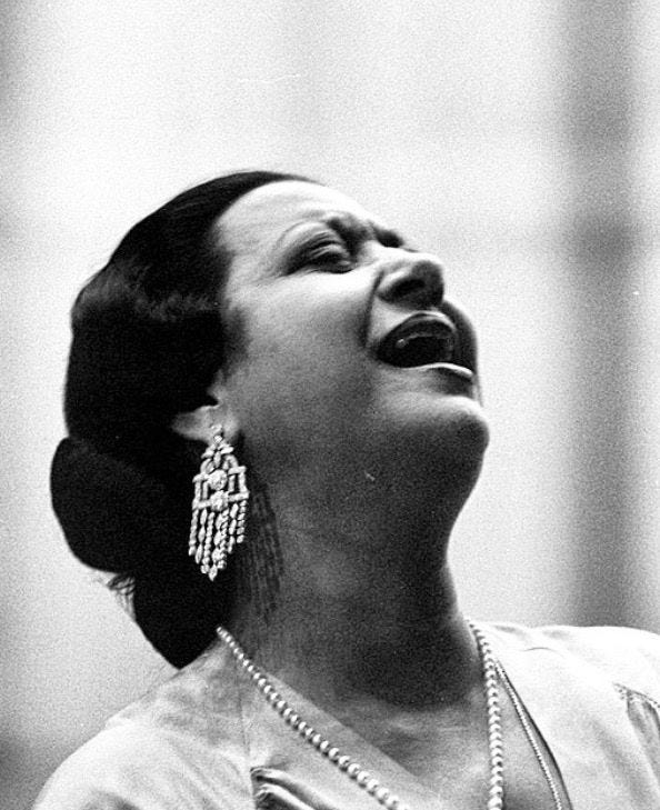 This may contain: a black and white photo of a woman singing This may contain: a black and white photo of a woman singing