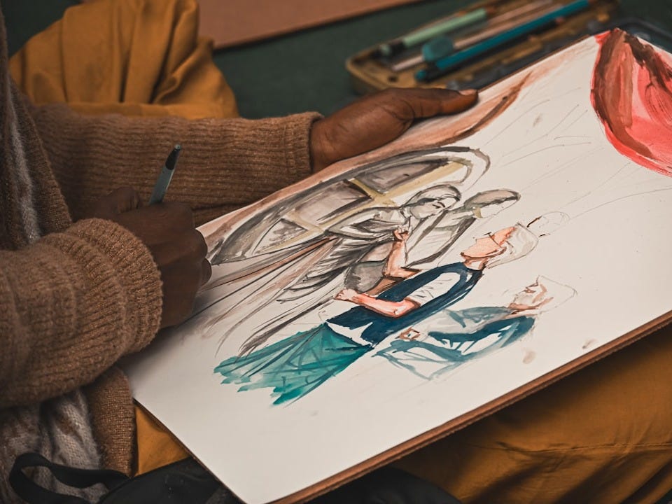 A woman sitting on the floor drawing a picture A woman sitting on the floor drawing a picture