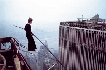 On this date- Philippe Petit performs his famous Walk between the twin towers of WTC in 1974, 1312 feet above the ground on a 200 kg cable and a 30ft long balancing On this date- Philippe Petit performs his famous Walk between the twin towers of WTC in 1974, 1312 feet above the ground on a 200 kg cable and a 30ft long balancing