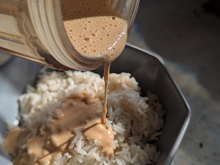 Peanut drizzle going on cooked rice. Finished bowl with optional toppings.