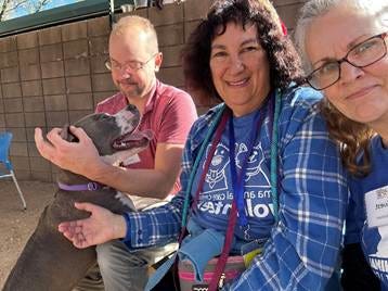 A group of people with a dog

AI-generated content may be incorrect.