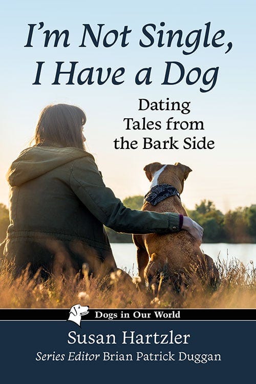 I'm Not Single, I Have a Dog book cover by Susan Hartzler featuring a woman and her dog sitting together by a lake at sunset.