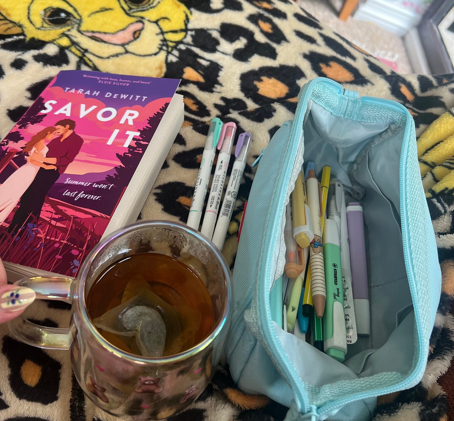 Savor It by Tarah Dewitt next to a pencil case with pens