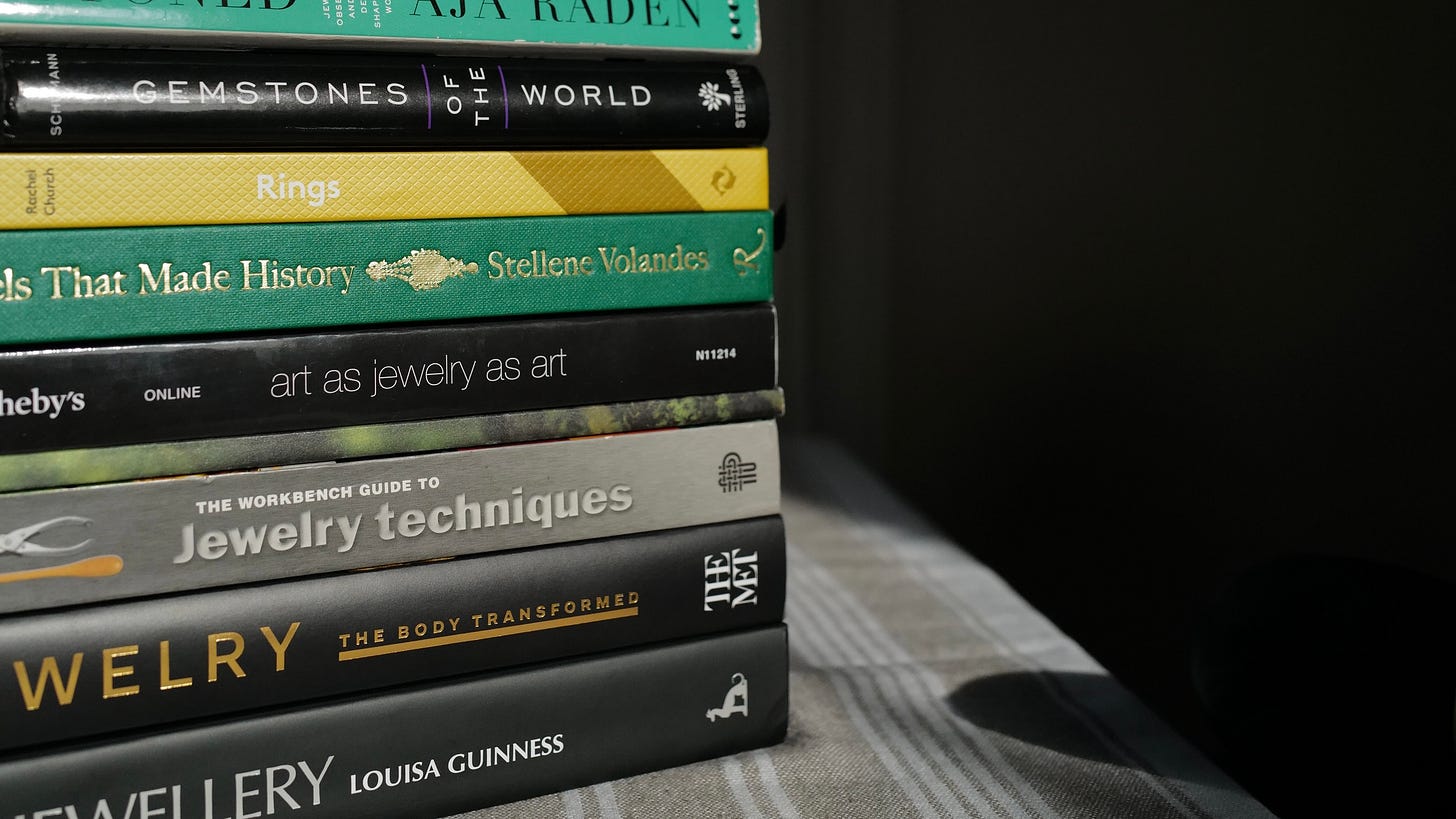 Pile of books resting on striped tablecloth