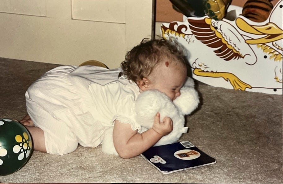 A baby lying on the floor with a stuffed animal

AI-generated content may be incorrect.