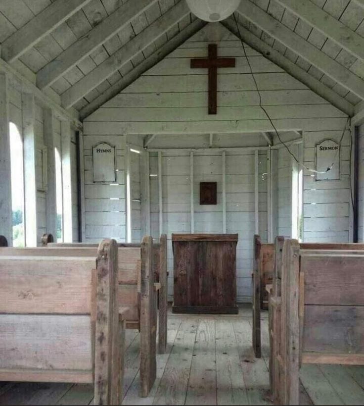 A wooden church with a cross on the ceiling

Description automatically generated