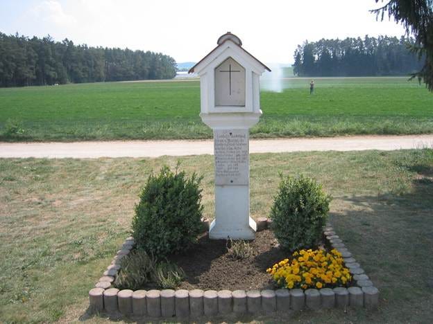 The Hinterkaifeck Murders Shrine near the vicinity of the crime scene. The shrine reads "On March 31, 1922, the Gabriel-Gruber family fell victim to the ungodly hand of the murderer". It goes on to include the names and years of birth of the victims.