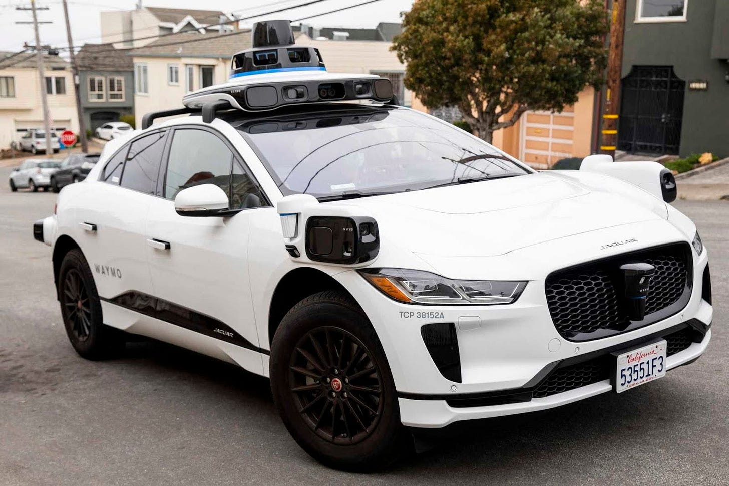 A Waymo robotaxi pulls up to a home during a demonstration ride in the Sunset District of San Francisco, Calif. Wednesday, August 25, 2021. Waymo's robo taxis are now offering rides to select members of the public in San Francisco who are accepted into its testing program.