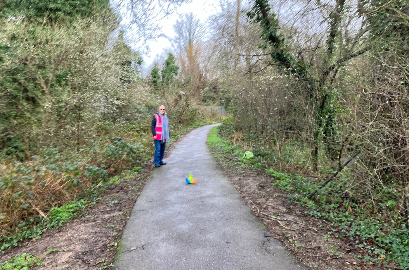 A cone in the middle of the path with a marshal marks the turnaround point