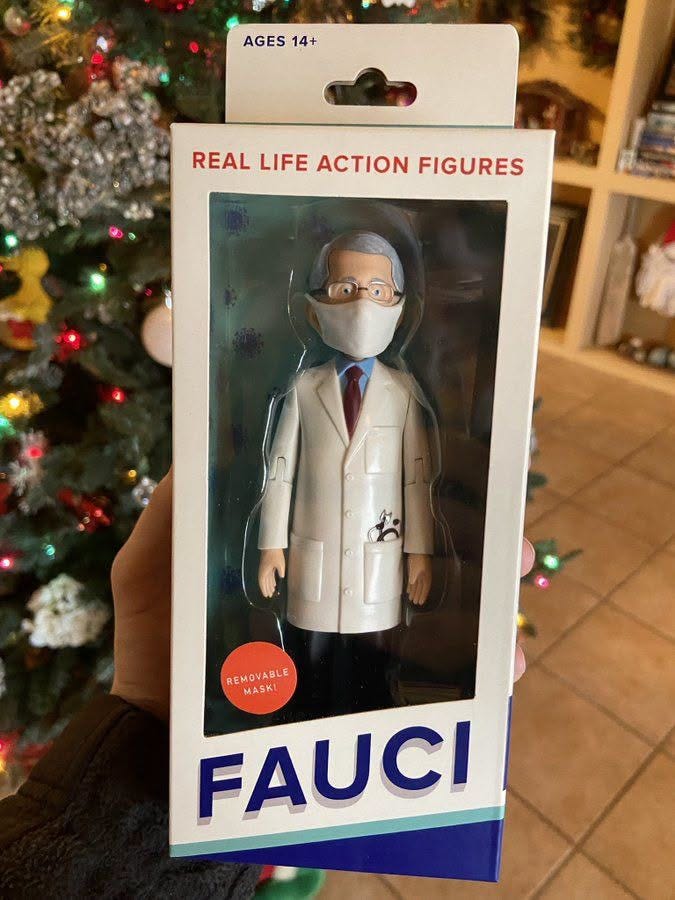 May be an image of toy and text that says 'AGES AGES14+ 14+ REALLIFEACTIONFIGURES REAL LIFE ACTION FIGURES REMOVABLE MASKI FAUCI' May be an image of toy and text that says 'AGES AGES14+ 14+ REALLIFEACTIONFIGURES REAL LIFE ACTION FIGURES REMOVABLE MASKI FAUCI'