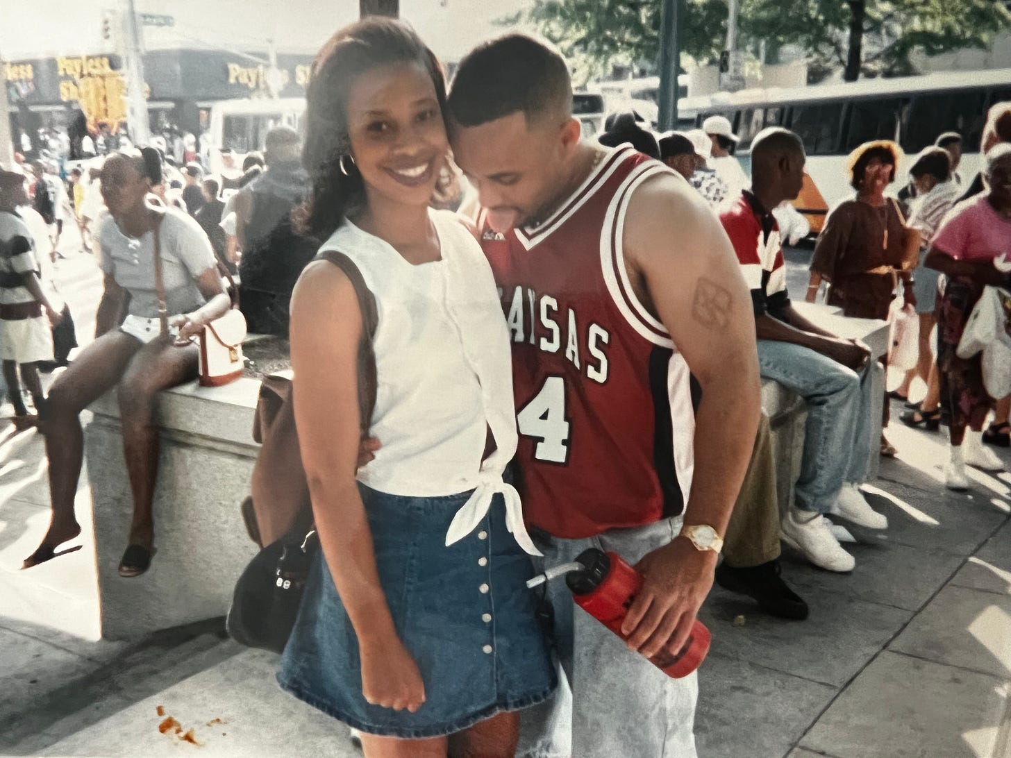 Young Diane Marie Brown at Freaknik next to a leering young man with his tongue out
