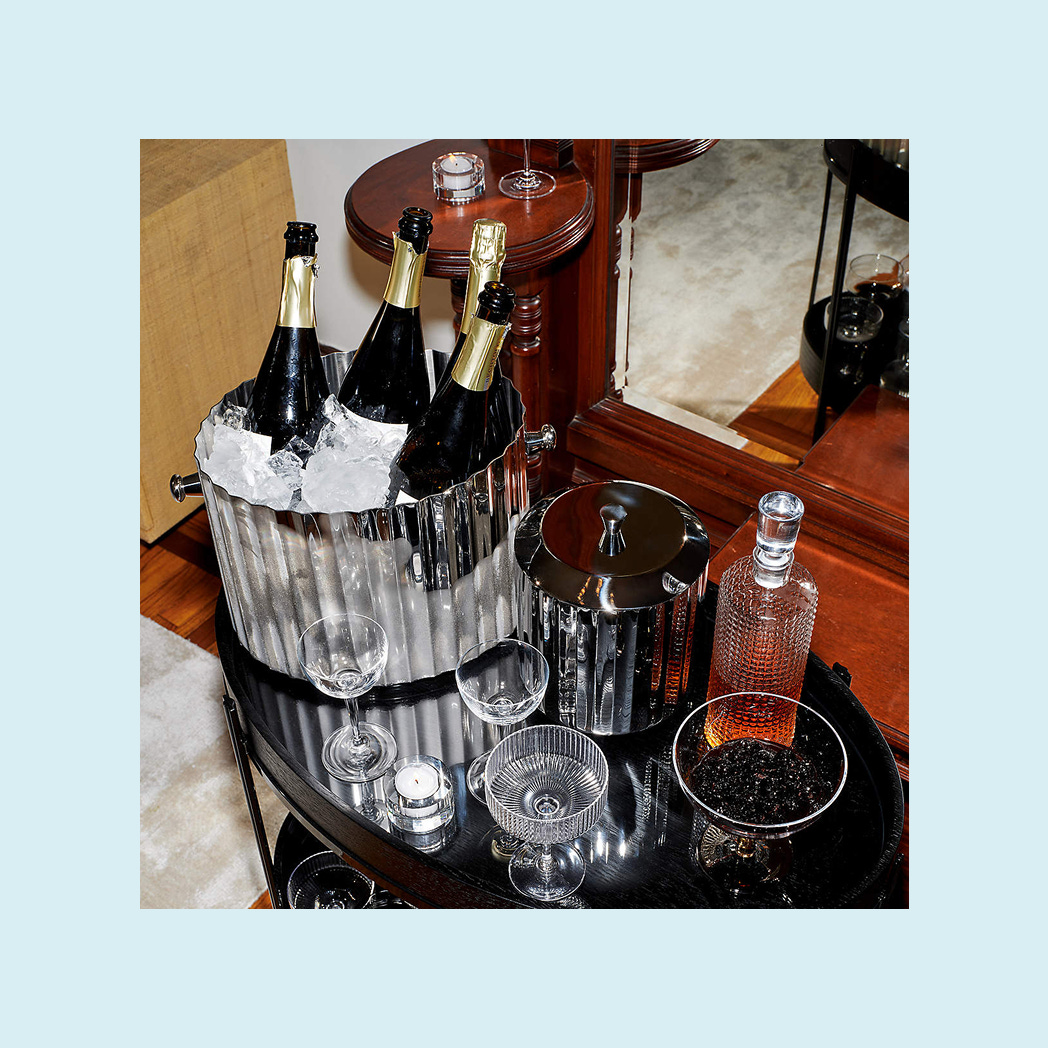 A silver ice bucket filled with champagne