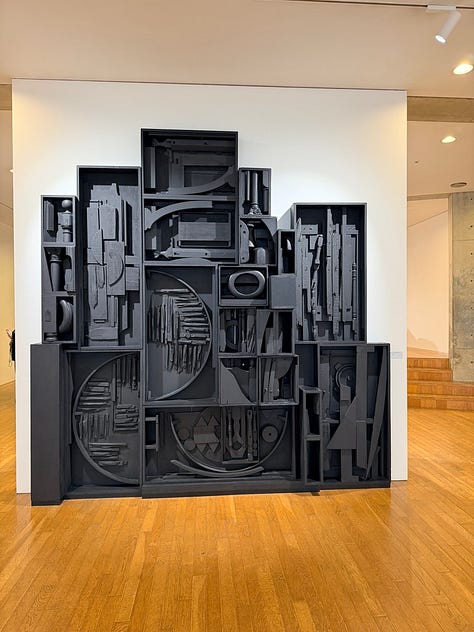 A grid of nine images depicting artworks by various artists, including Bruce Nauman, Jannis Kounellis, John Chamberlain, Yves Klein, Louise Nevelsen, Jenny Holzer, and Kan Yasuda.