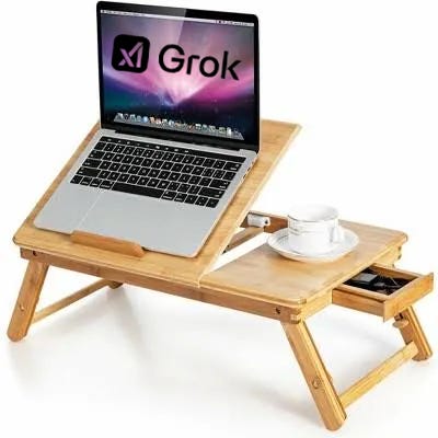 Bed tray with laptop showing Apartheid Twitter's Grok AI logo Bed tray with laptop showing Apartheid Twitter's Grok AI logo