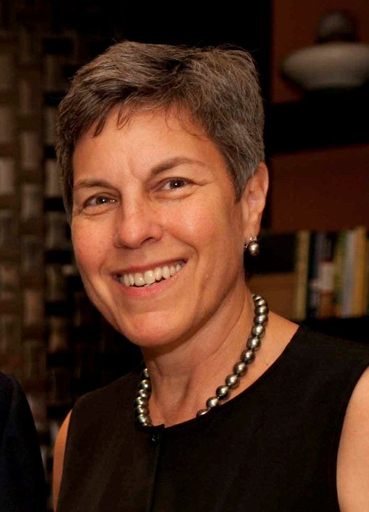 Headshot of woman smiling, wearing black sleeveless top Headshot of woman smiling, wearing black sleeveless top