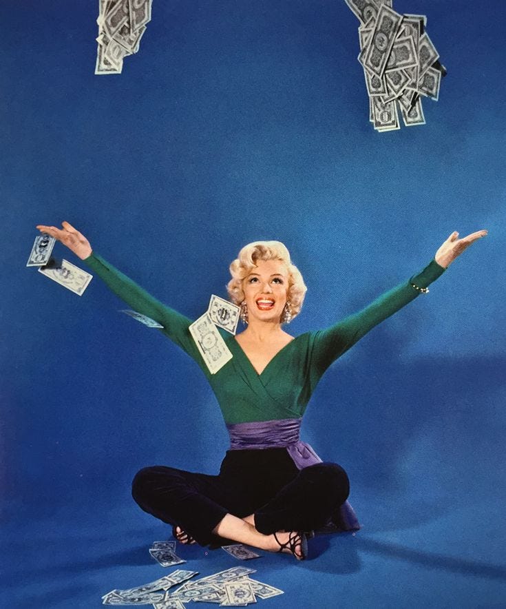 This may contain: a woman sitting on the ground with money falling from her arms and hands in the air