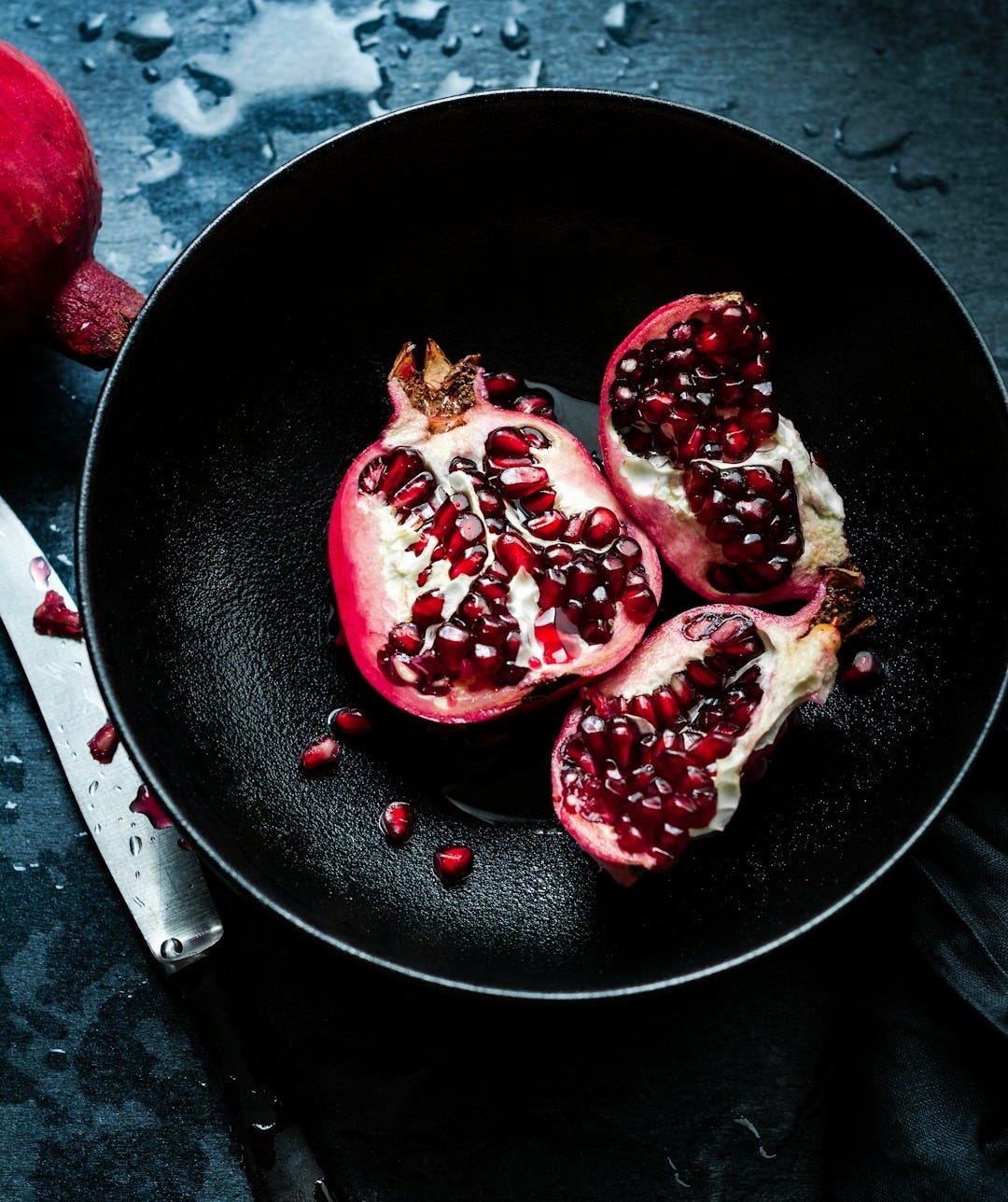 pomegranates in a frying pan on a table