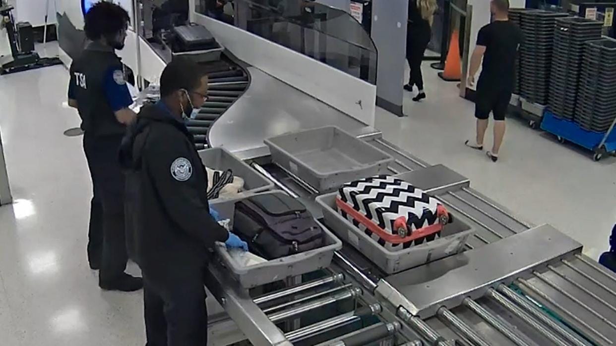 Still from video of TSA officers charged with grand theft released by Miami-Dade State Attorney's office. Still from video of TSA officers charged with grand theft released by Miami-Dade State Attorney's office.