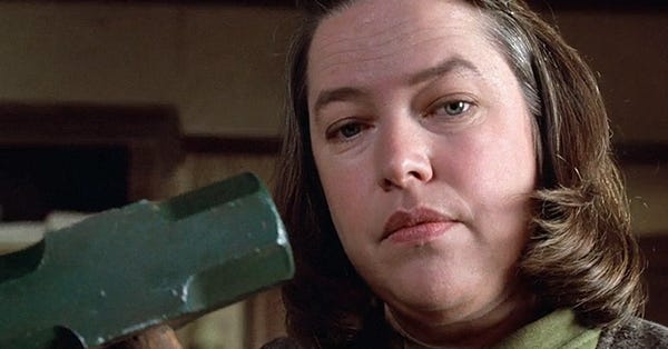 Kathy Bates in Misery holding a sledge hammer.