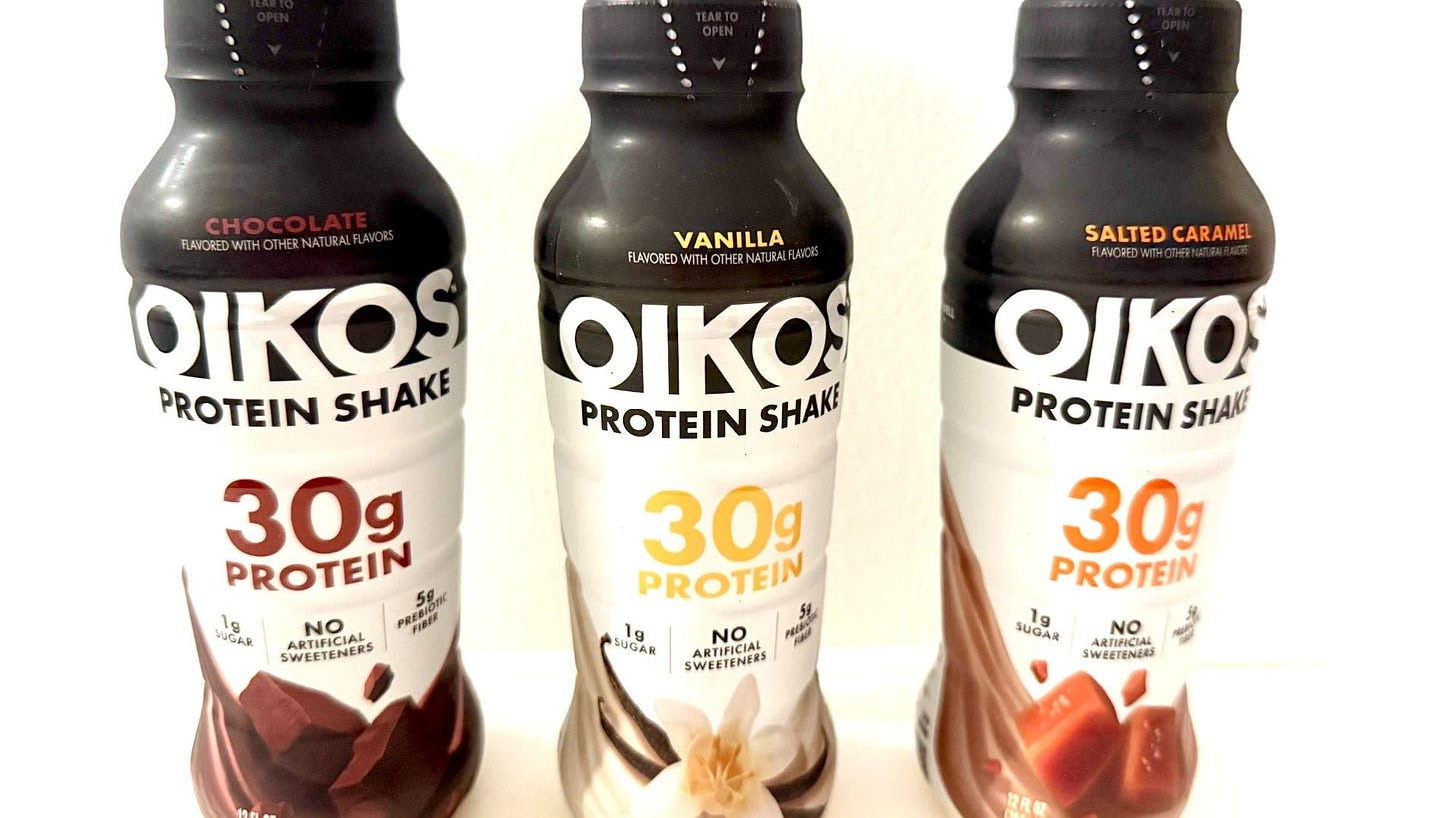 Three bottles of Oikos brand protein shakes