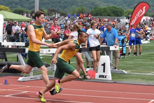 Kaiser Neverman makes a handoff for the Preble boys 800-meter relay. Kaiser Neverman makes a handoff for the Preble boys 800-meter relay.