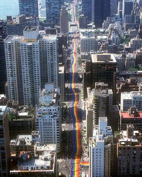 Three historical images showing Gilbert Baker’s mile-long rainbow flag from 1994. The first is an aerial view of the flag running down a packed New York City street. The second shows Gilbert Baker sitting on the flag in a park, surrounded by people holding it up. The third is a street-level view of LGBTQIA+ activists marching with a section of the flag in front of St. Patrick’s Cathedral, raising fists and celebrating queer liberation.