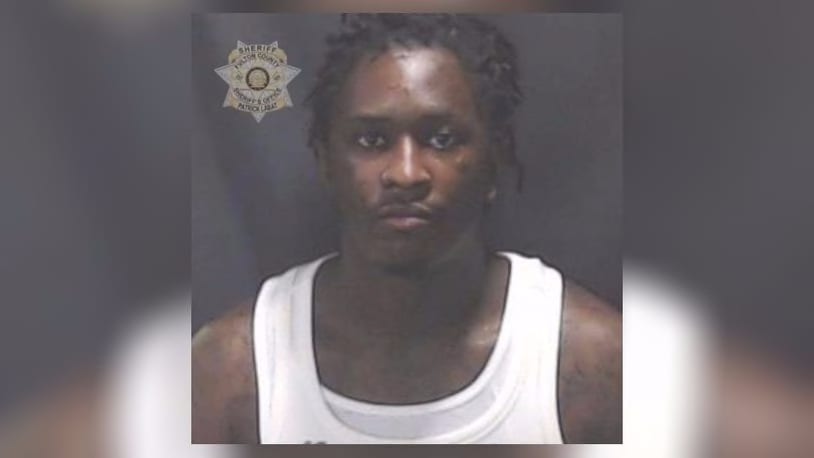 Atlanta rapper Young Thug was booked into the Fulton County Jail on two gang-related charges Monday.