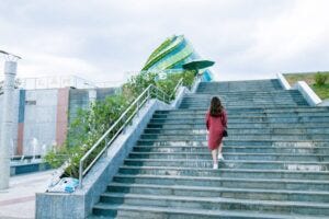 woman walking up stairs outside