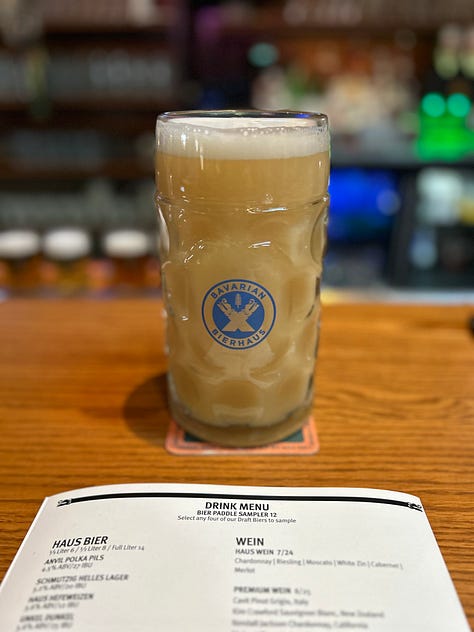food, beer, stein, hall, tables, chairs, sign