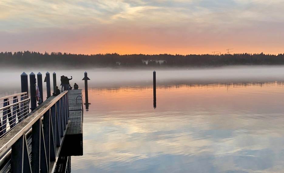 A dock with a body of water and fog

AI-generated content may be incorrect.