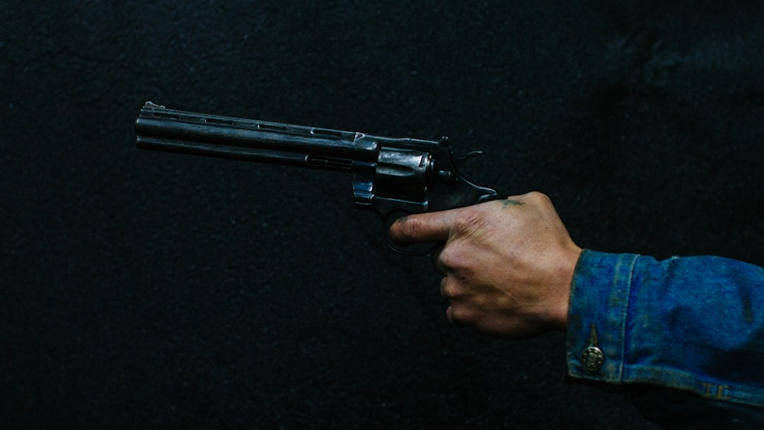 A revolver held at the ready in a man's hand