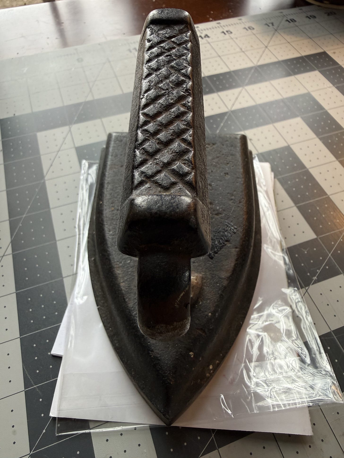 antique cast iron clothes iron on a cutting mat antique cast iron clothes iron on a cutting mat