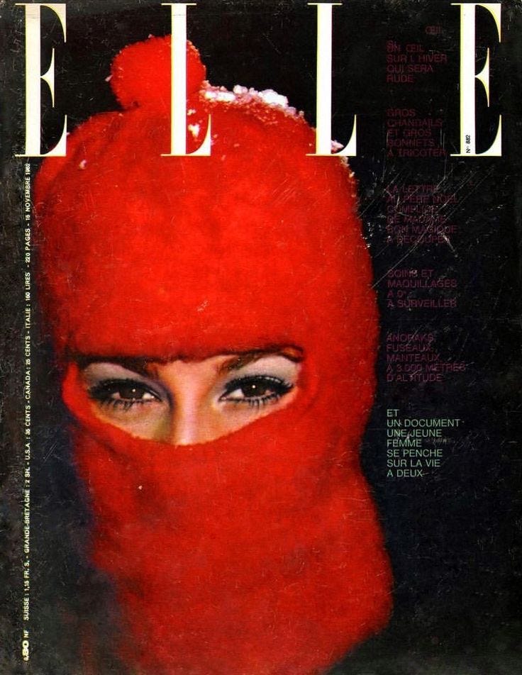 This may contain: a magazine cover with a woman wearing a red mask on her head and eyes covered in snow