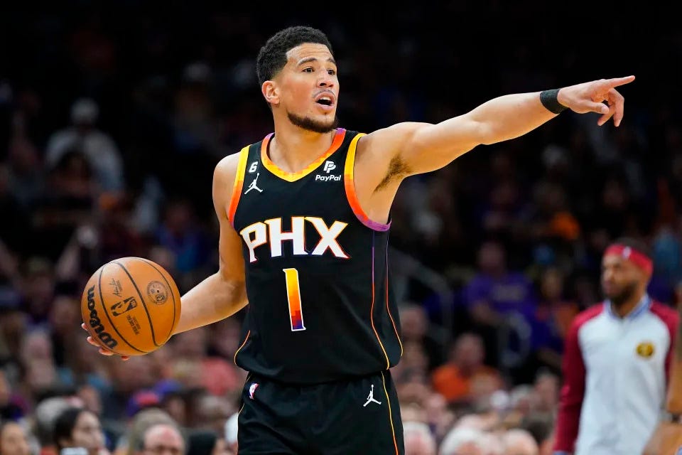 Phoenix Suns guard Devin Booker calls a play during the first half of Game 3 of the Western Conference semifinal series against the Denver Nuggets on May 5, 2023, at Footprint Center in Phoenix. (AP Photo/Matt York)
