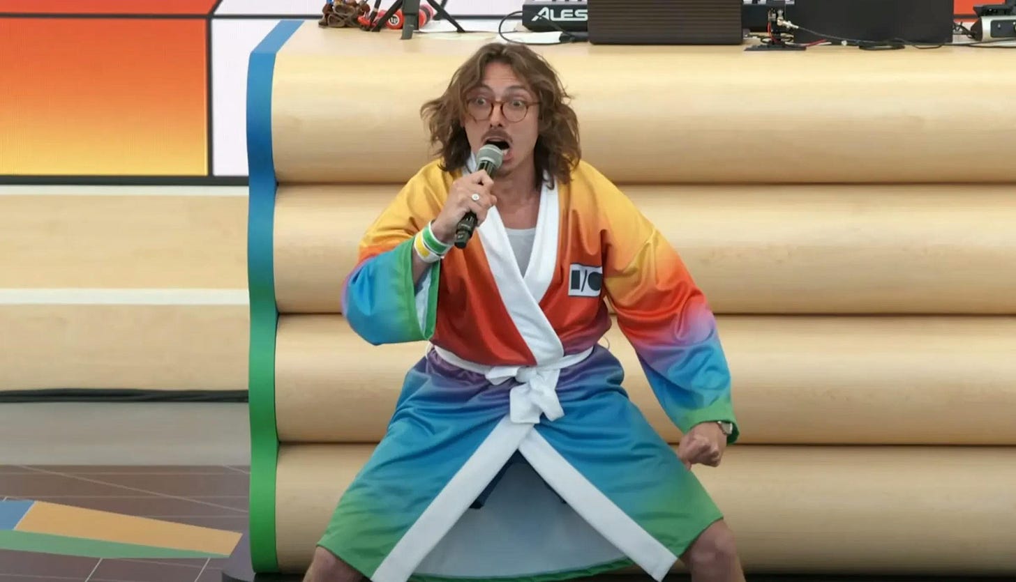 Marc Rebillet kicking off Google’s I/O event in a rainbow-colored bath robe Marc Rebillet kicking off Google’s I/O event in a rainbow-colored bath robe