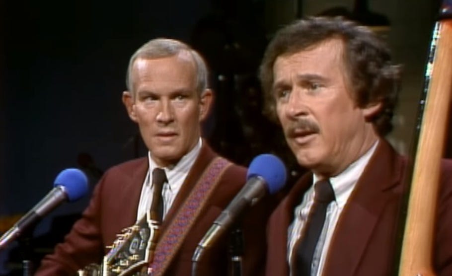 Video screenshot of Tom and Dick Smothers; Tom looks at Dick in pretended worry as Dick explains the song. Video screenshot of Tom and Dick Smothers; Tom looks at Dick in pretended worry as Dick explains the song.