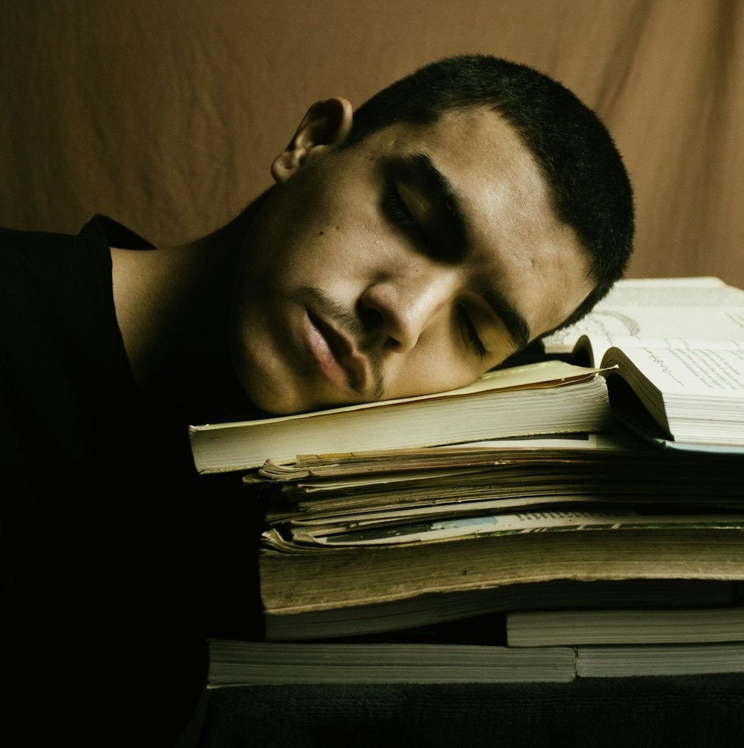 man in black shirt reading book